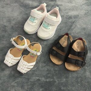 Three pairs of girls' shoes, two in size (5) and one in size (4)